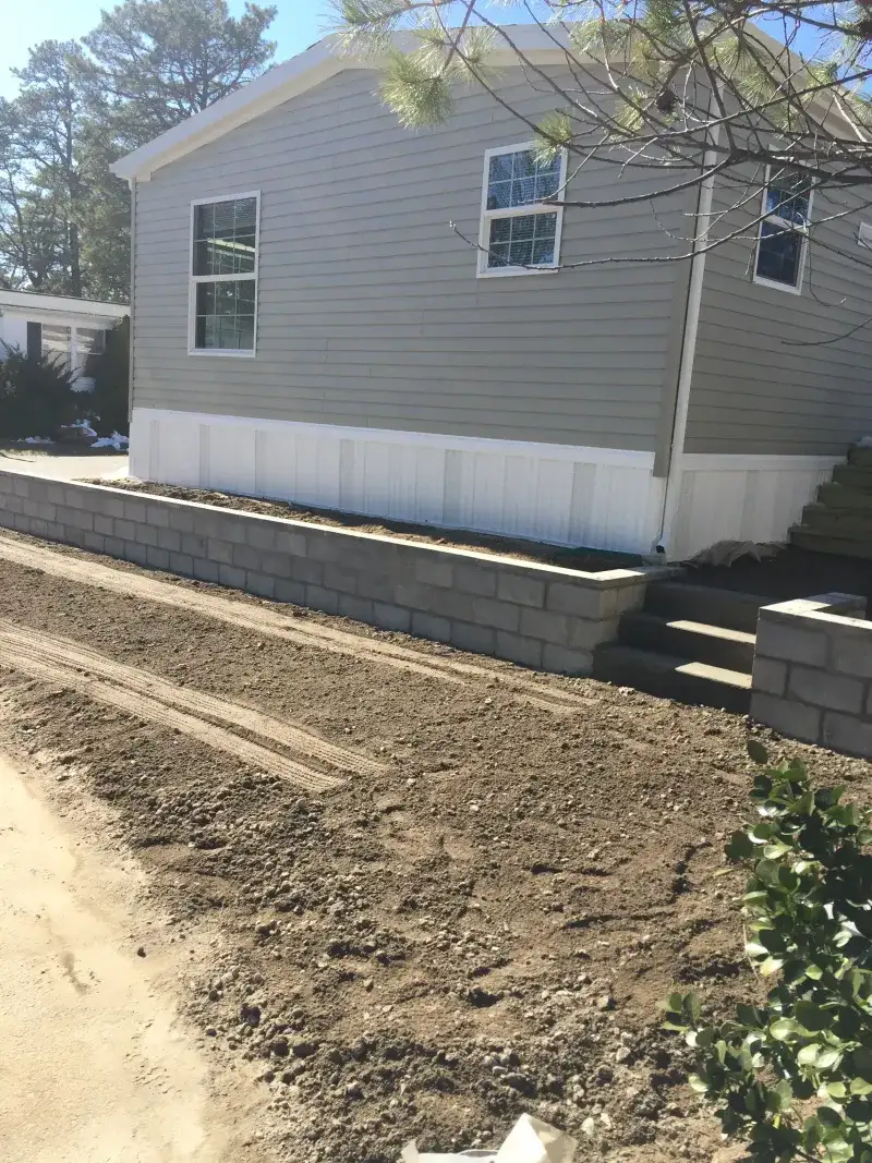 Asphalt Side Yard and Retaining Wall Repair - Before